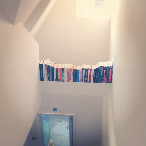 Handy bookshelf above the top staircase. Hacking my house.